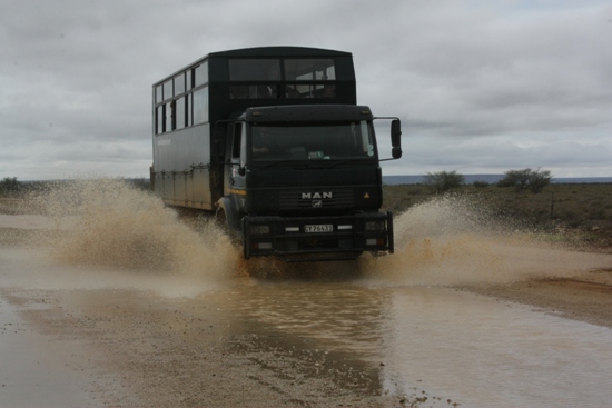 Truck racing through the water overland africa truck